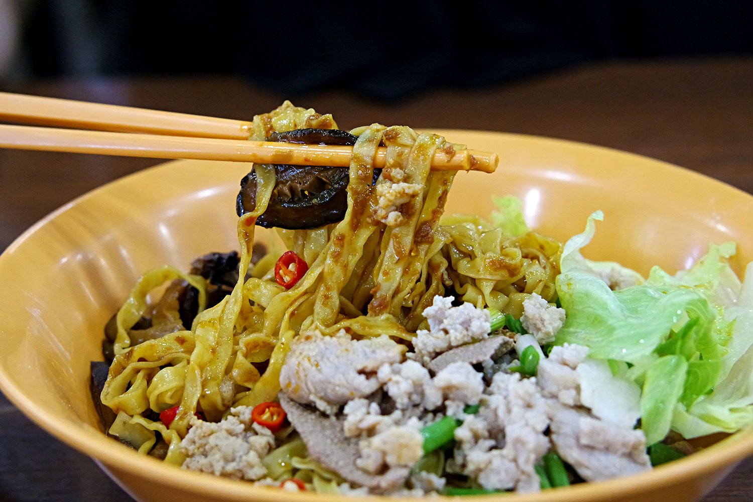 Thin egg noodles are tossed in with a house made chilli sauce, cooked pork mince, braised mushrooms, and generous lashings of vinegar
