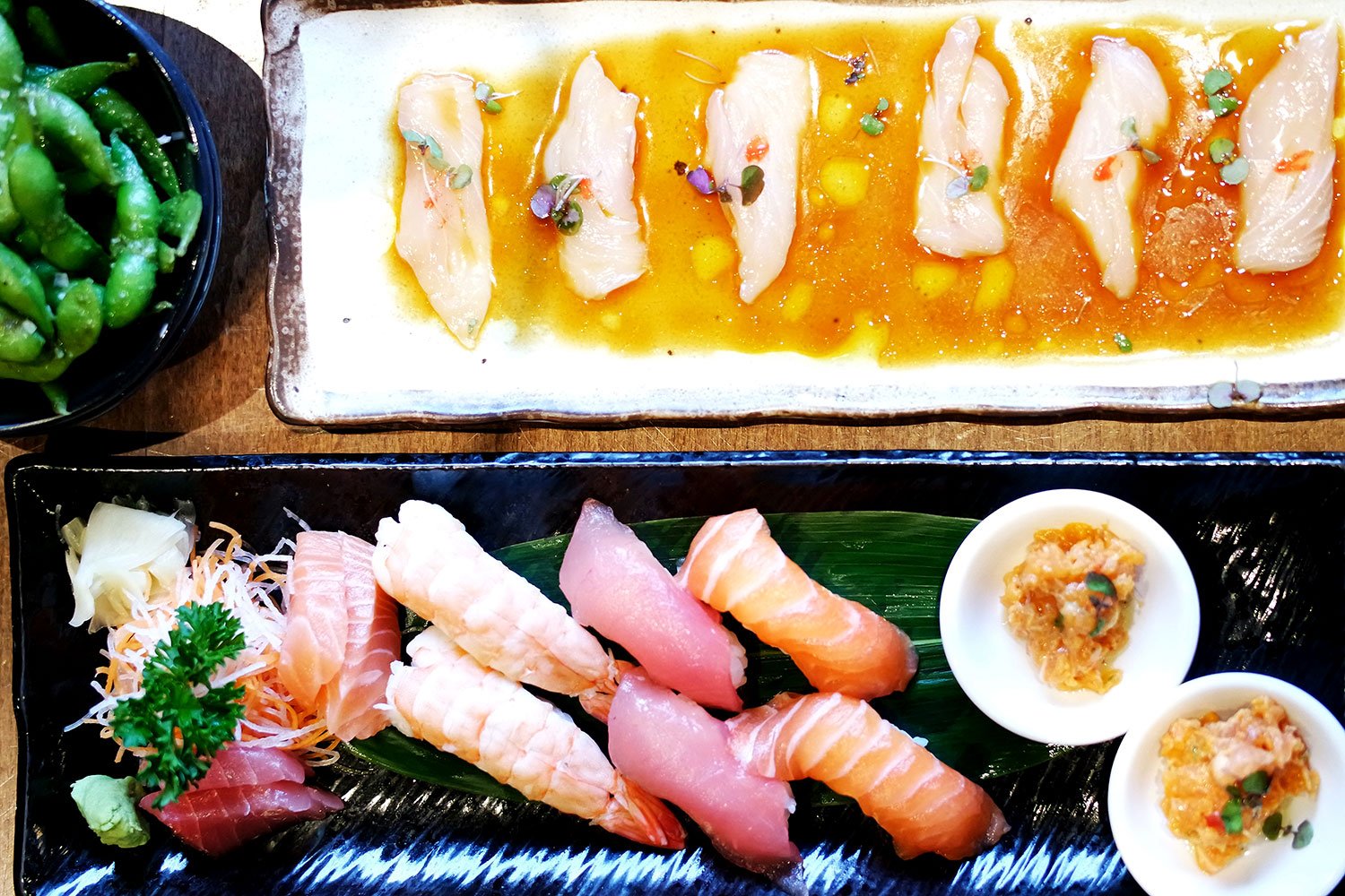 Clockwise from top left: pesto edamame, kingfish carpaccio, sushi and sashimi combination