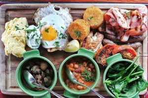 Poached, scrambled and fried eggs, toast and lebanese bread with sides of merguez sausage, bacon, roasted tomato, hash brown, grilled haloumi, mushrooms, baby spinach, and baked beans