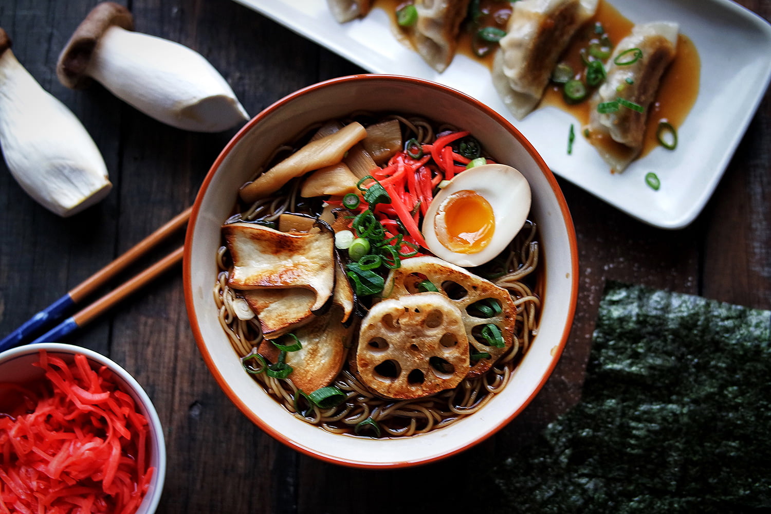 An aerial shot of the vegetarian shiitake mushroom ramen, with pickles and gyozas on the side.